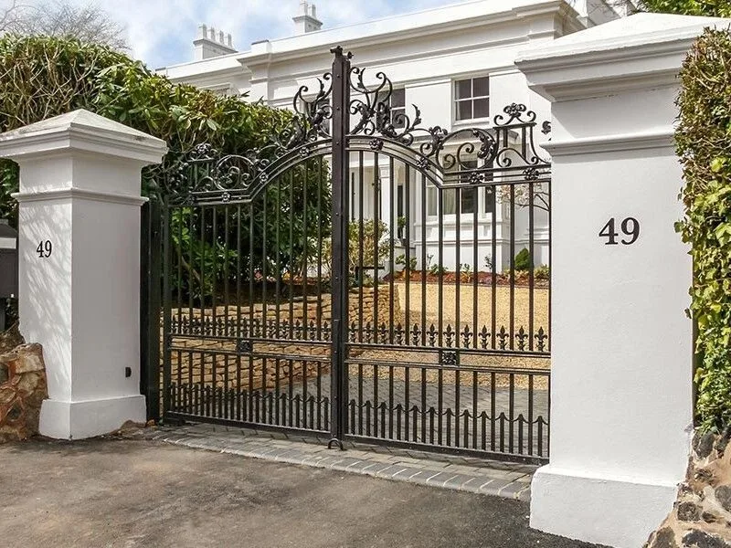 Ornate wrought iron estate gates at a residential entrance